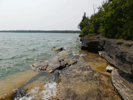 stratified rocky shoreline. bit of sunglimmer