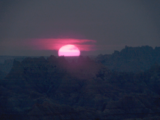 pink sunset over alien terrain (it's actually just the badlands again)