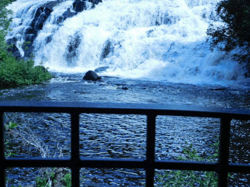 foreground- railing. background- bottom of waterfall