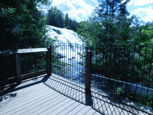 arched railing casting shadow, also the waterfall again