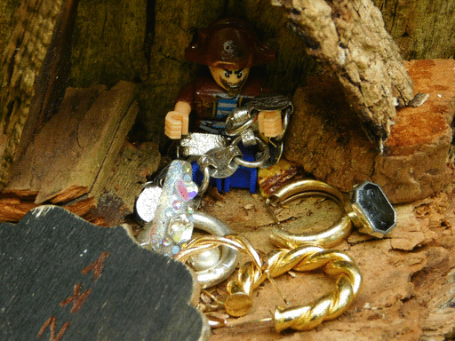 Close-up of the pirate figure. Perhaps this isn't exactly a shrine, after all- one of its arms and one of its legs are bound in a plasticky silver chain.