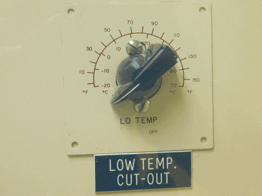 Close-up of the "LOW TEMP. CUT OUT" chickenhead knob on base plate with label below. The base plate has screw holes in the corners but is actually fixed by screws above and below the knob. The plate has a radial scale reading 0 - 160 degrees F on the outside, with odd multiples of 10 labeled, and -20 to 70 degrees C on the inside, with every multiple of 10 labeled. Below the knob is written "LO TEMP," and below that and a bit to the right, in smaller text, "OFF".